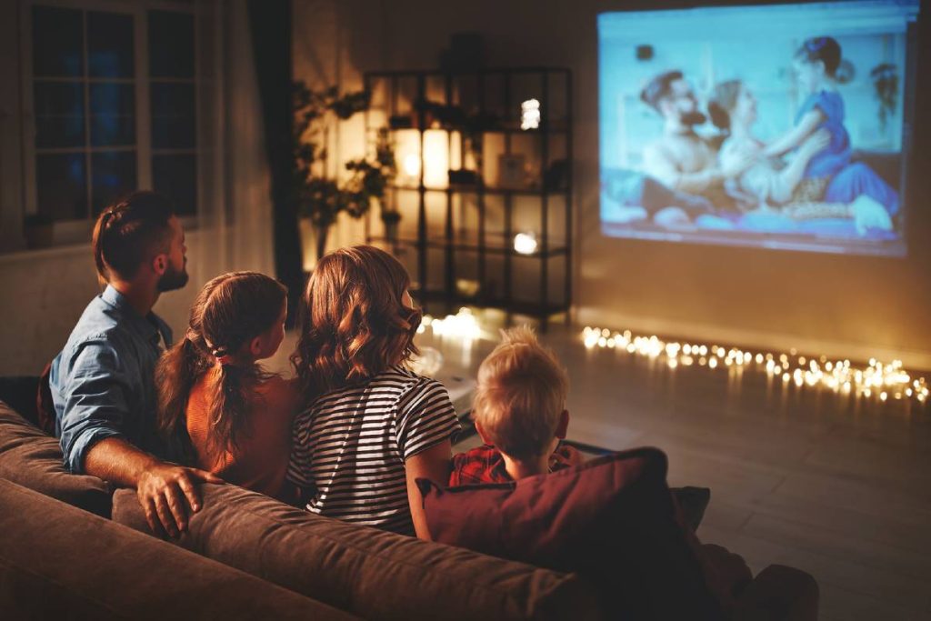 Family watching movie using projector