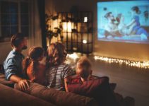 Family watching movie using projector