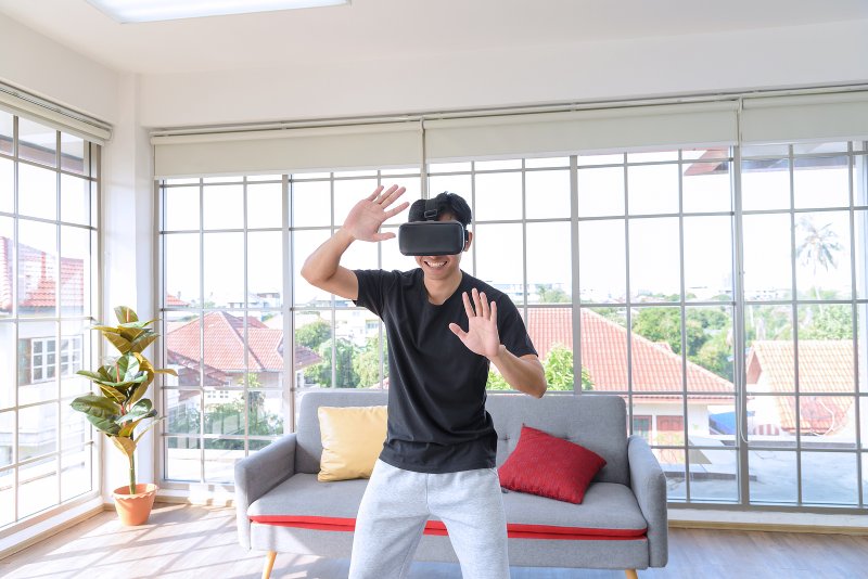 Man wearing VR headset in living room